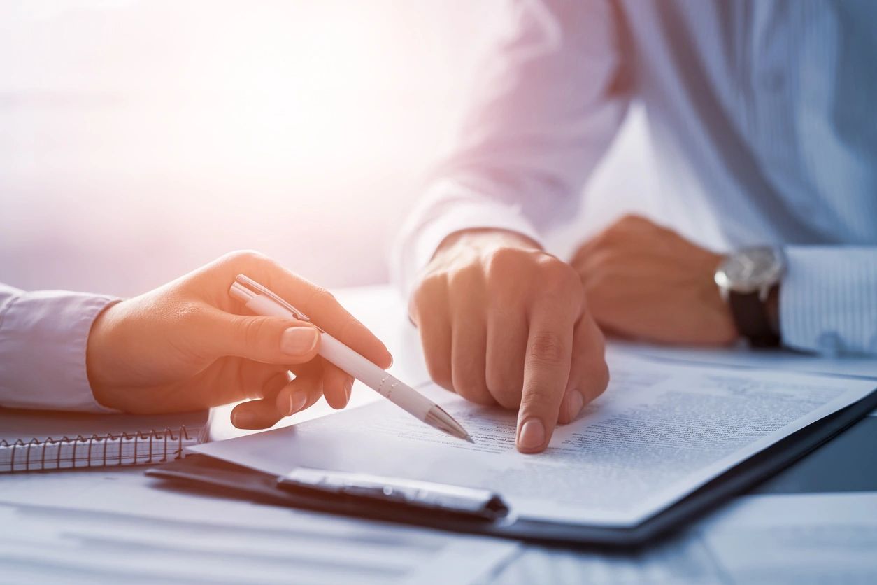 Two people reviewing a document